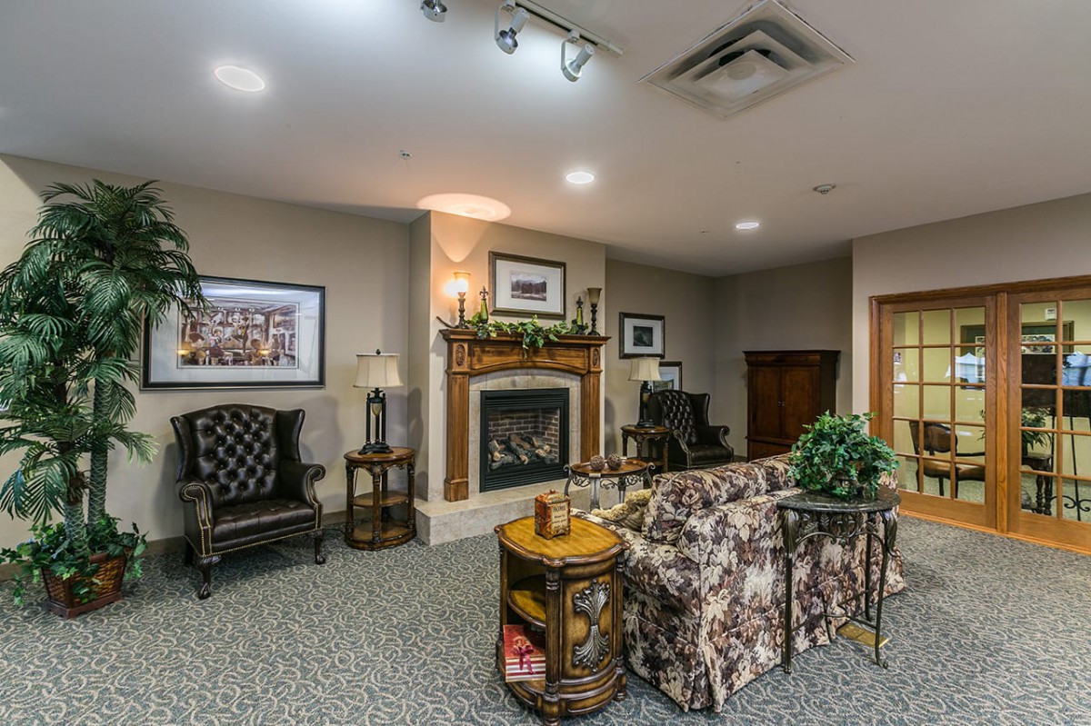A cozy living room with a fireplace, seating area, and elegant decor.