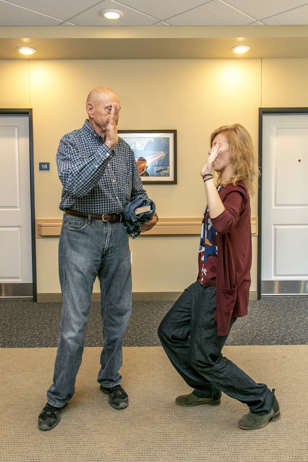 Two people sharing a high five in a casual indoor setting.