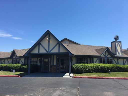 A charming residential building with a unique architectural design under a clear blue sky.