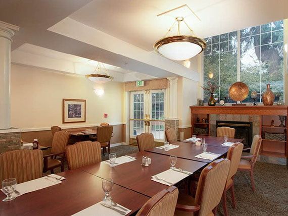 A well-lit conference room with a large table and chairs arranged for a meeting.