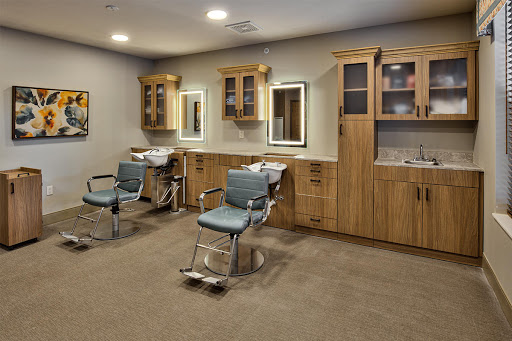 A modern dental office featuring comfortable chairs and wooden storage cabinets.