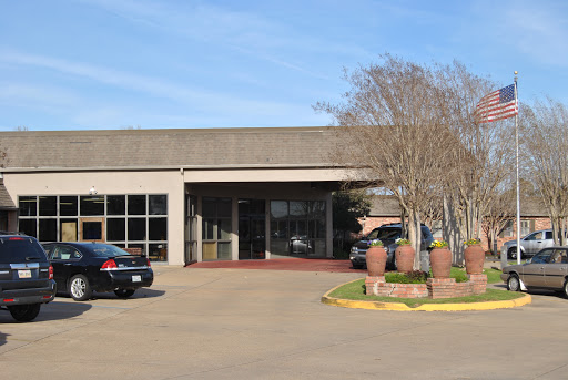 A modern commercial building with a welcoming entrance and surrounding landscaping.