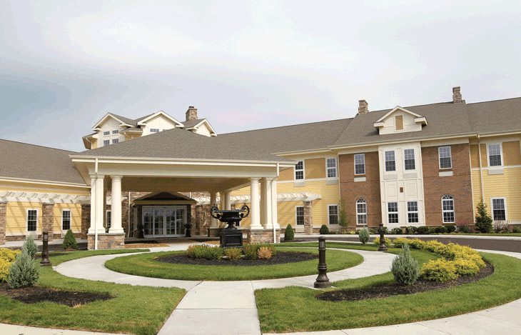 A large residential building with a welcoming entrance and landscaped surroundings.