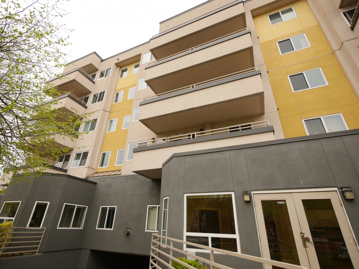 A modern apartment building with multiple balconies and a contemporary design.
