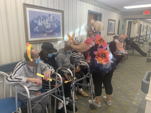 Residents enjoying a lively activity with staff at a care facility.