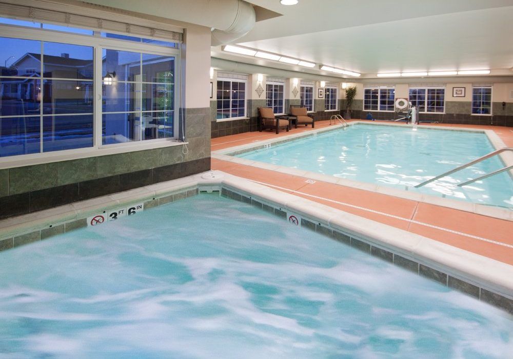 An inviting indoor pool area featuring a hot tub and swimming pool, perfect for relaxation and leisure.