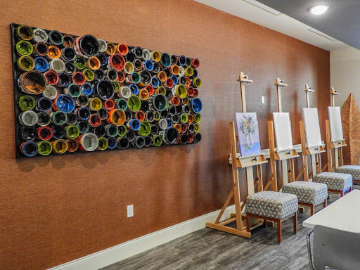 A vibrant art studio with easels and colorful wall art, ready for creative projects.