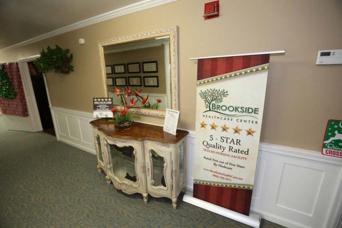 A reception area featuring a banner and award display on a vintage console table.