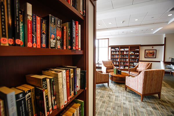 A cozy library with bookshelves and a comfortable reading area.
