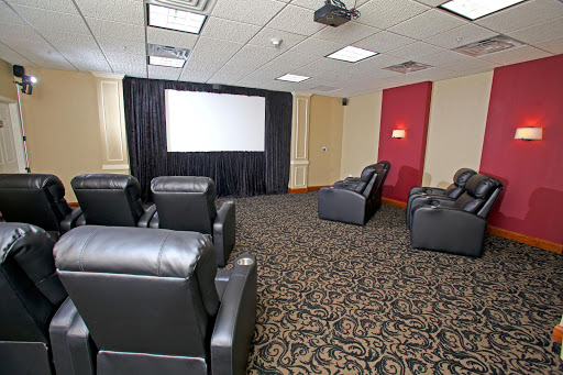 A cozy home theater setup with recliner seating and a large screen for movie nights.