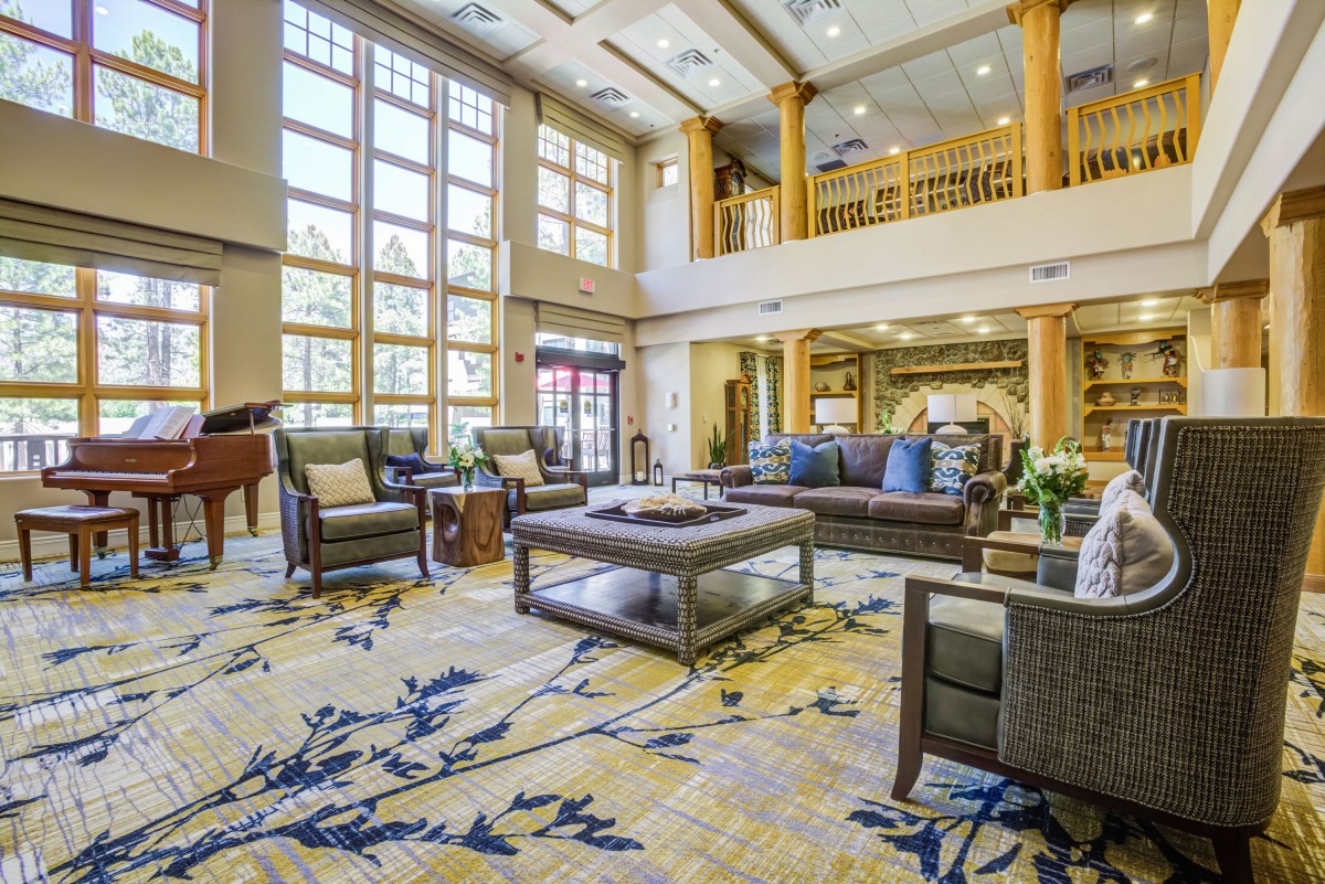 A luxurious hotel lobby with elegant furniture and spacious seating area.
