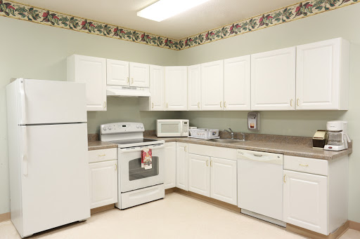 A well-equipped kitchen featuring white cabinetry and modern appliances.