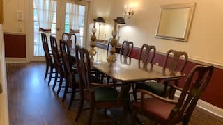 A traditional dining room with an elegant table and chairs set.