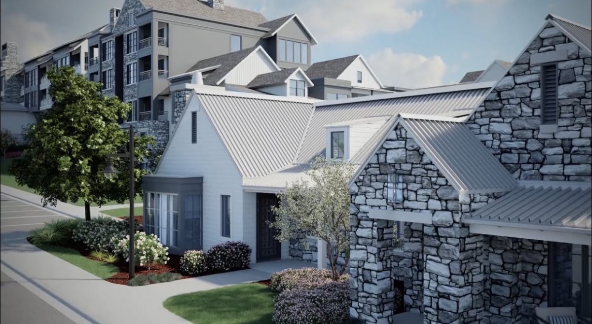 A modern residential building with stonework elements and well-maintained landscaping.