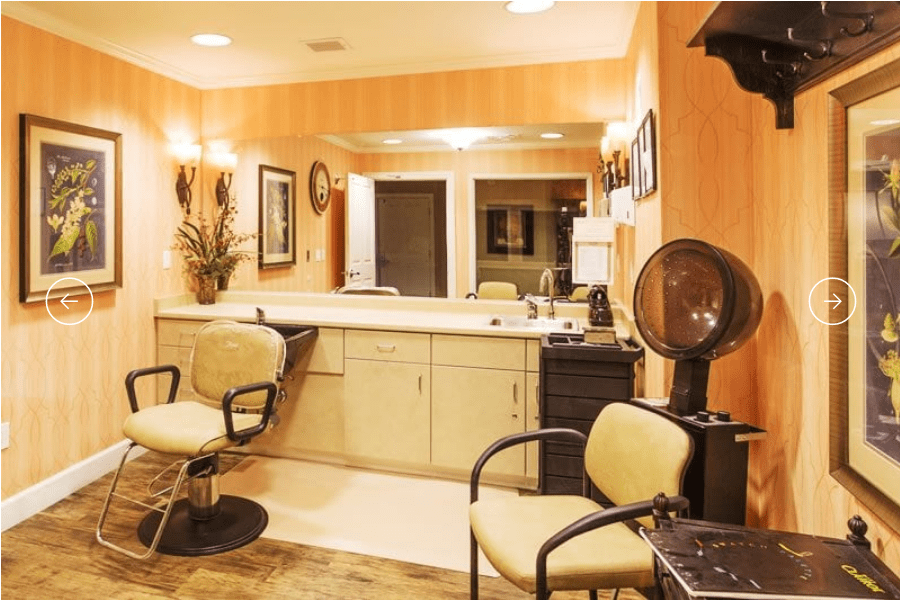 Interior of a salon with styling chairs and hairdressing equipment.