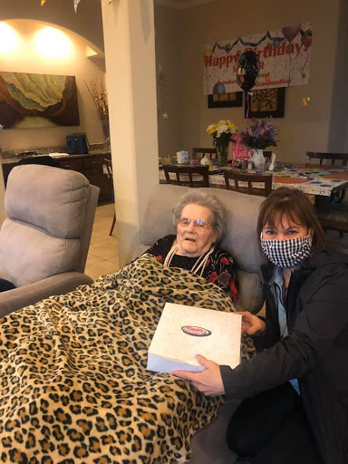 A joyful moment shared between friends as they celebrate with cake at home.