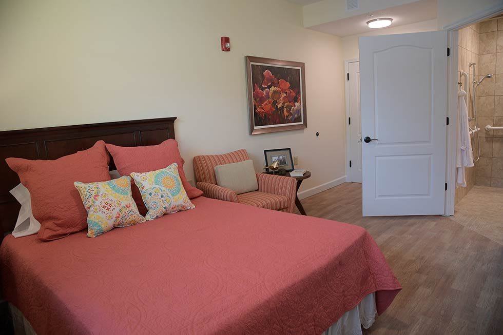 A cozy bedroom with warm-toned bedding and decor.