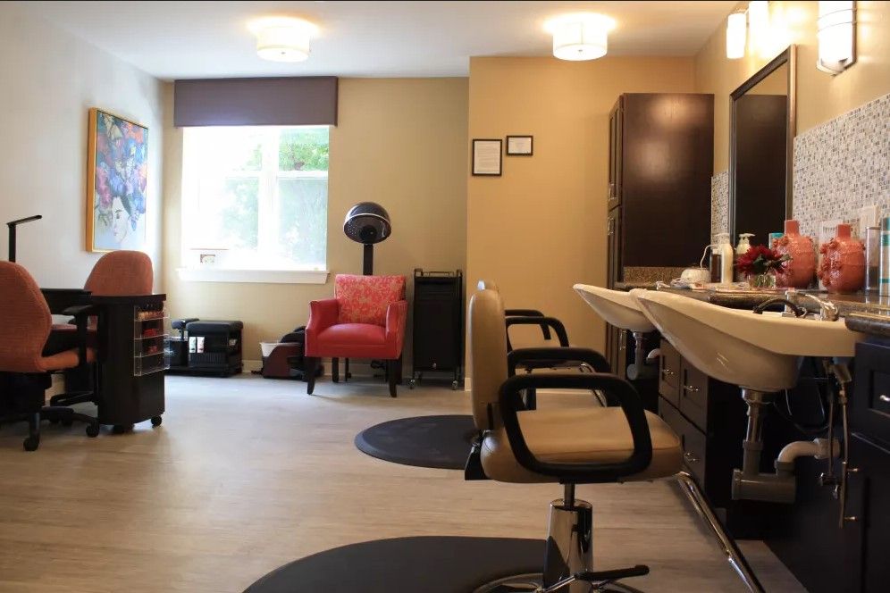 Interior of a modern salon with chairs and mirrors.