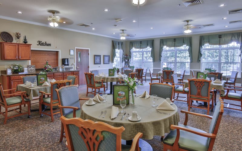 An elegantly designed dining room with neatly arranged tables and chairs.