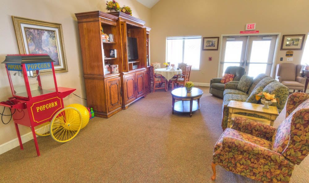 A cozy living room with a wooden cabinet, television, and comfortable seating.