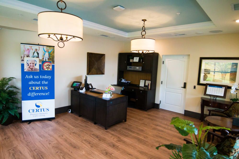 A modern office reception area with a desk and decorative lighting.