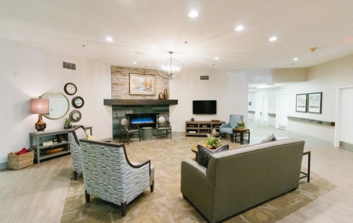 A stylish living room with modern decor, featuring a fireplace and comfortable seating.