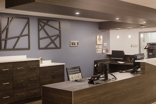 A modern office reception area featuring sleek furniture and a professional atmosphere.