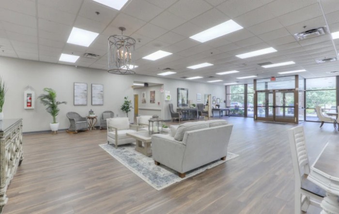 A modern waiting room with comfortable seating and bright lighting.