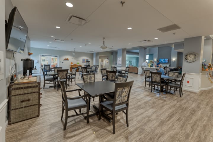 A modern and spacious dining area with neatly arranged tables and chairs, featuring stylish decor and ample lighting.