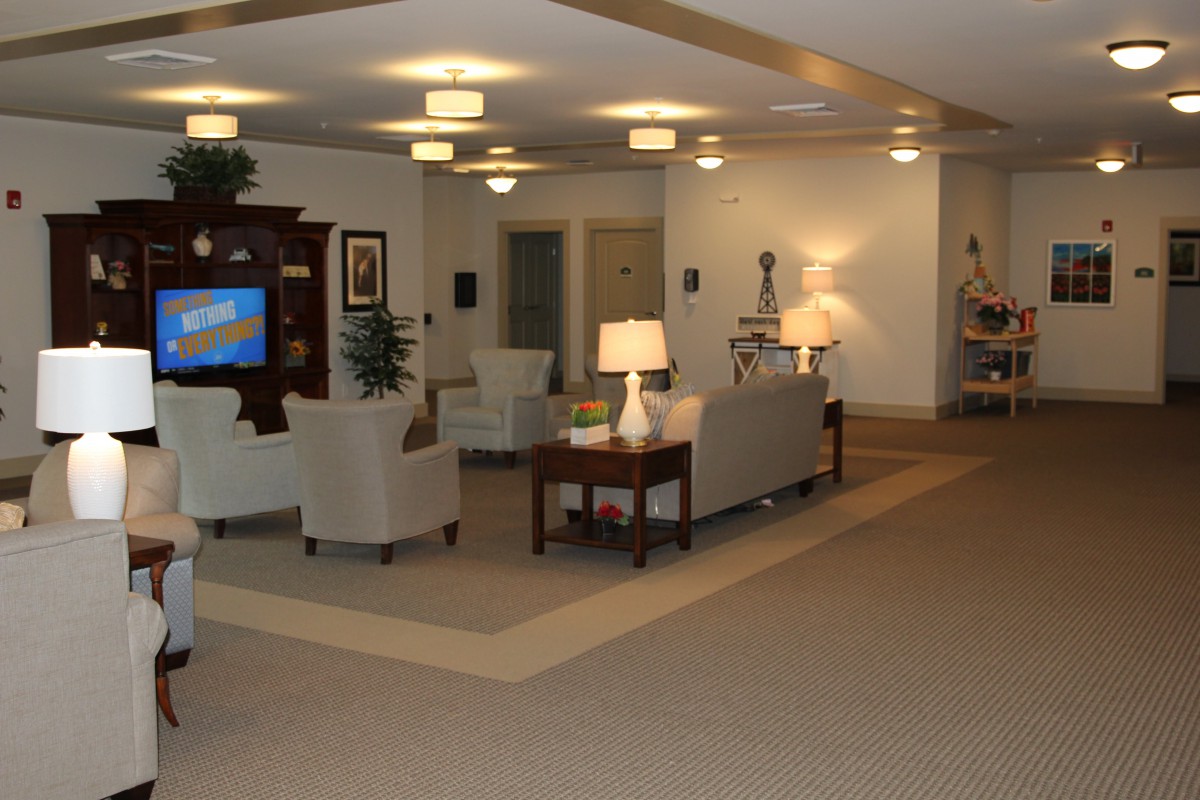 A modern living room with comfortable seating and soft lighting.