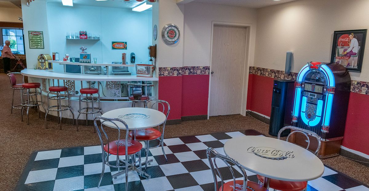 A retro-style diner with checkerboard flooring and vintage decor.