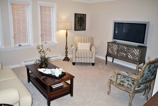 A cozy and elegantly designed living room featuring comfortable seating, warm lighting, and tasteful decor.