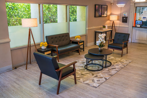 A stylish and inviting living room area featuring cozy seating, modern furniture, and ample natural light.