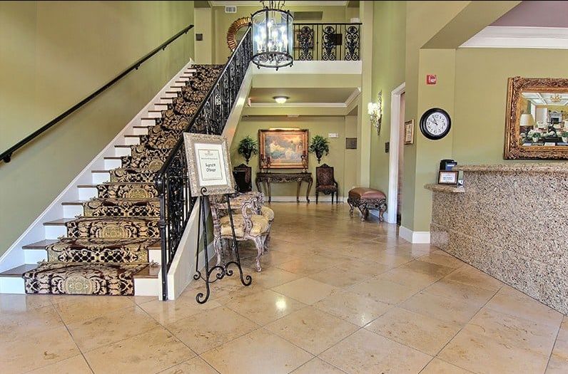 A spacious hotel lobby with a grand staircase and elegant decor.