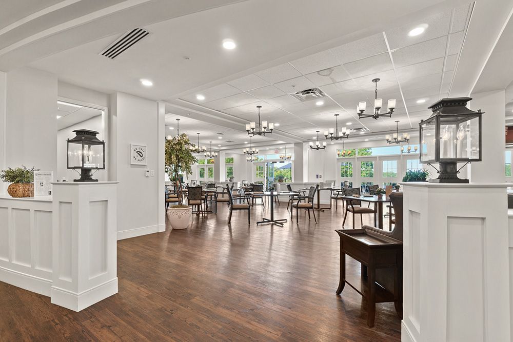 A spacious and elegantly designed restaurant interior with modern furnishings and lighting.