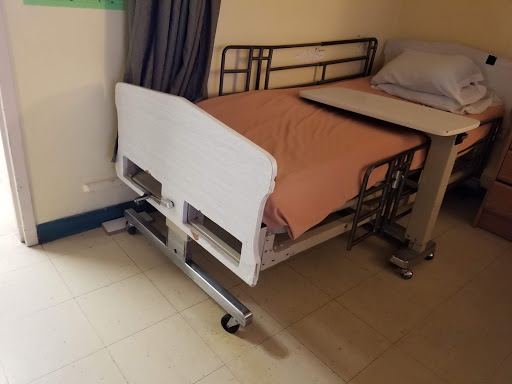 A hospital bed prepared for patient use.