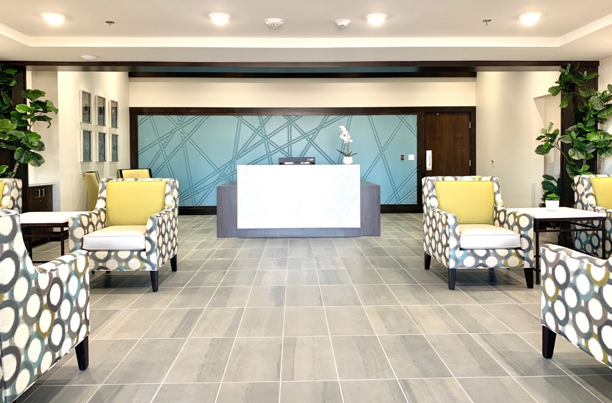 A modern office lobby with stylish seating and a reception desk.