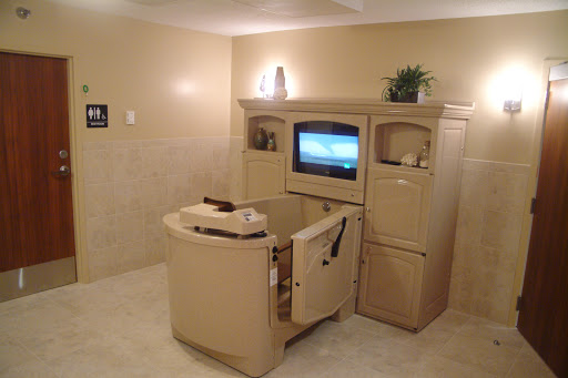 A cozy bathroom space featuring an entertainment unit with a television, perfect for relaxation.