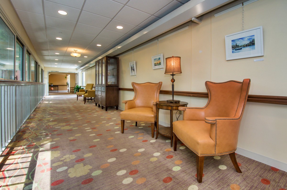 A well-lit hallway with comfortable seating and elegant decor.