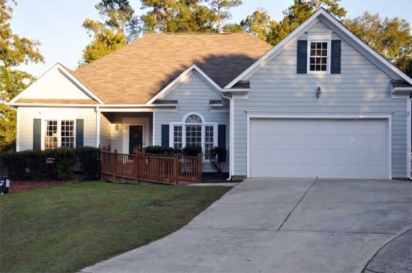 A suburban single-story house with a garage and front yard.