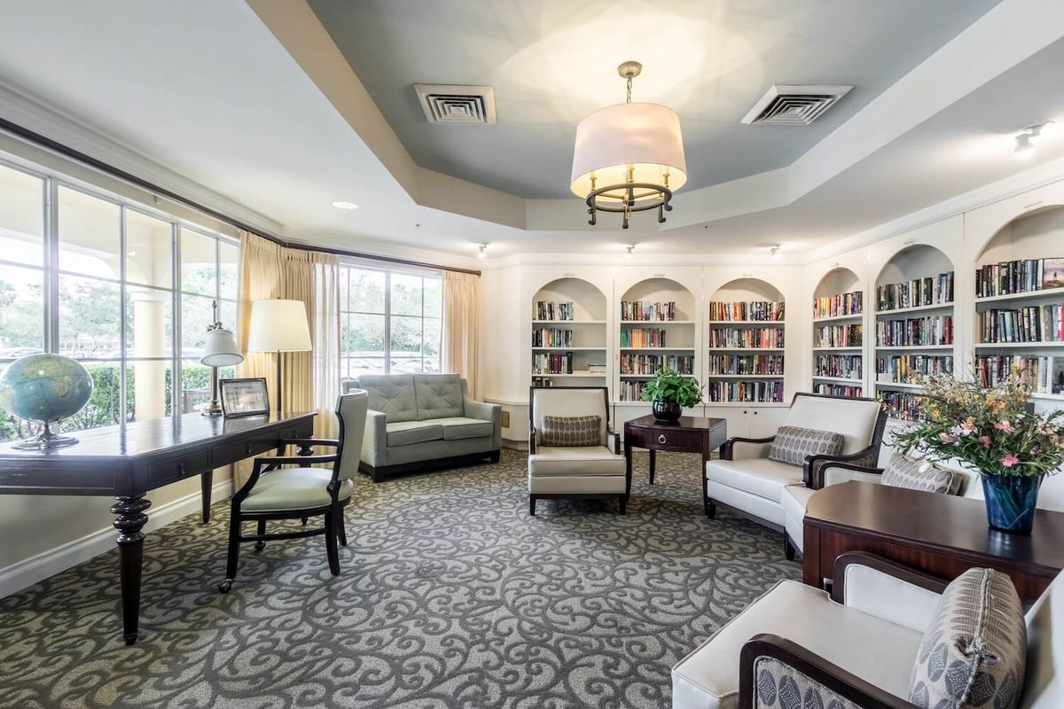 A cozy library reading area with comfortable seating and bookshelves.