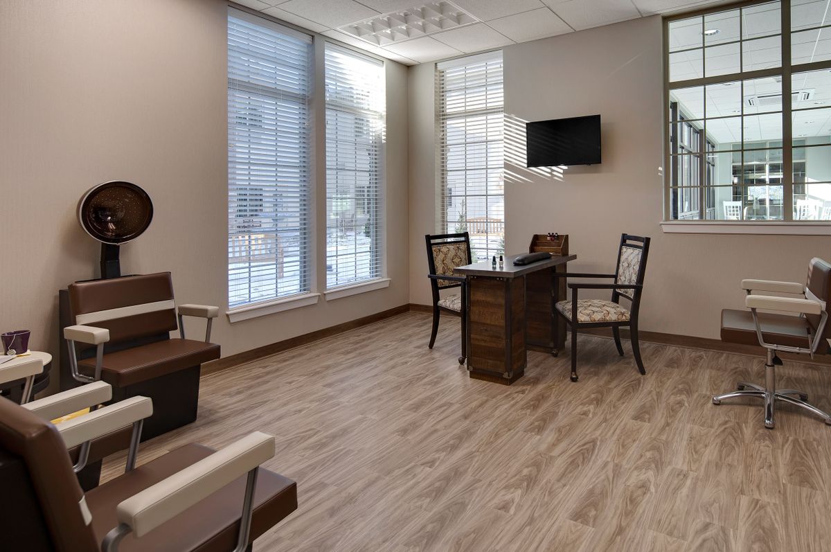 A modern office meeting room with large windows and minimalist furnishings.