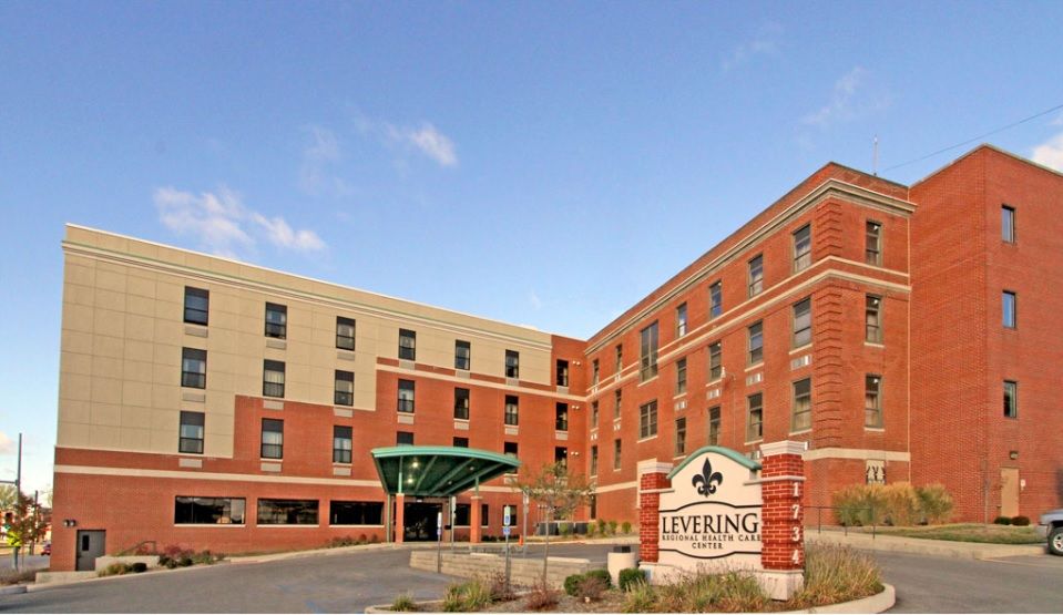 A modern hotel building with a brick exterior and welcoming entrance.