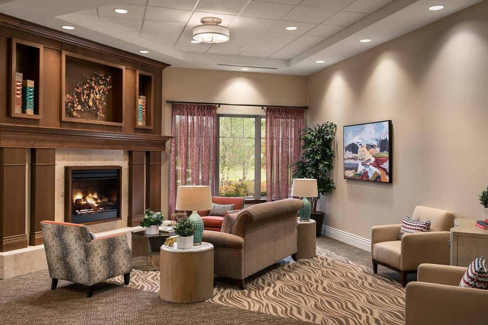 A cozy living room with a fireplace, comfortable sofas, and elegant decor.