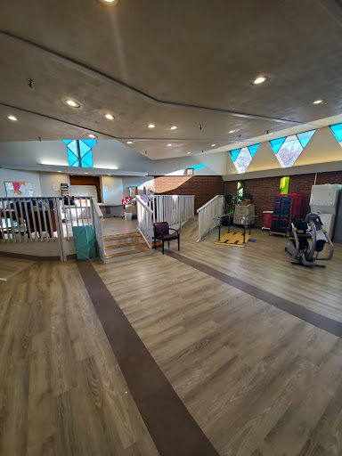 A spacious gym area equipped with exercise machines and a welcoming atmosphere.