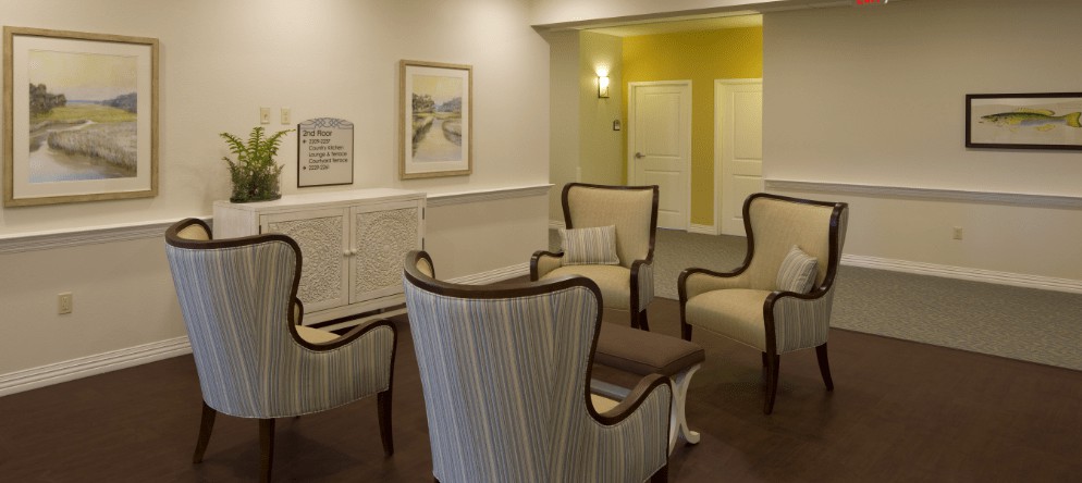 A cozy seating area with elegant chairs arranged for conversation in a warmly decorated room.