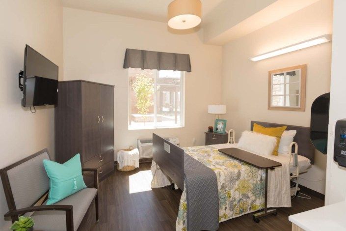 A cozy bedroom with a single bed, window, and minimalistic furniture.