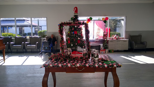 A beautifully decorated table featuring a Christmas tree surrounded by festive ornaments.