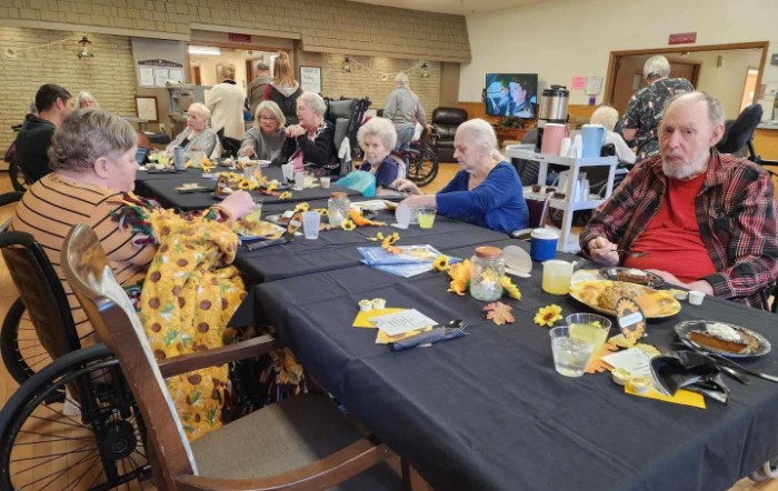 A group of seniors enjoying a meal together at a community gathering.