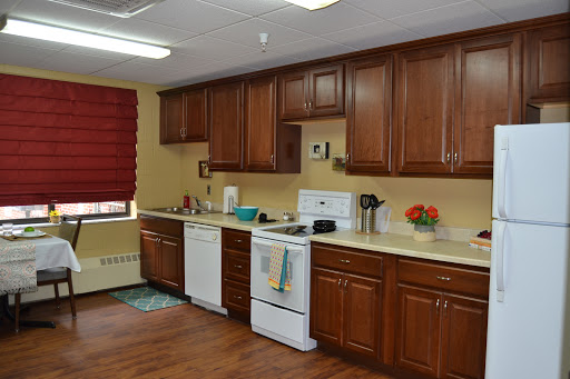 A well-organized and modern kitchen featuring wooden cabinets, white appliances, and a cozy atmosphere.